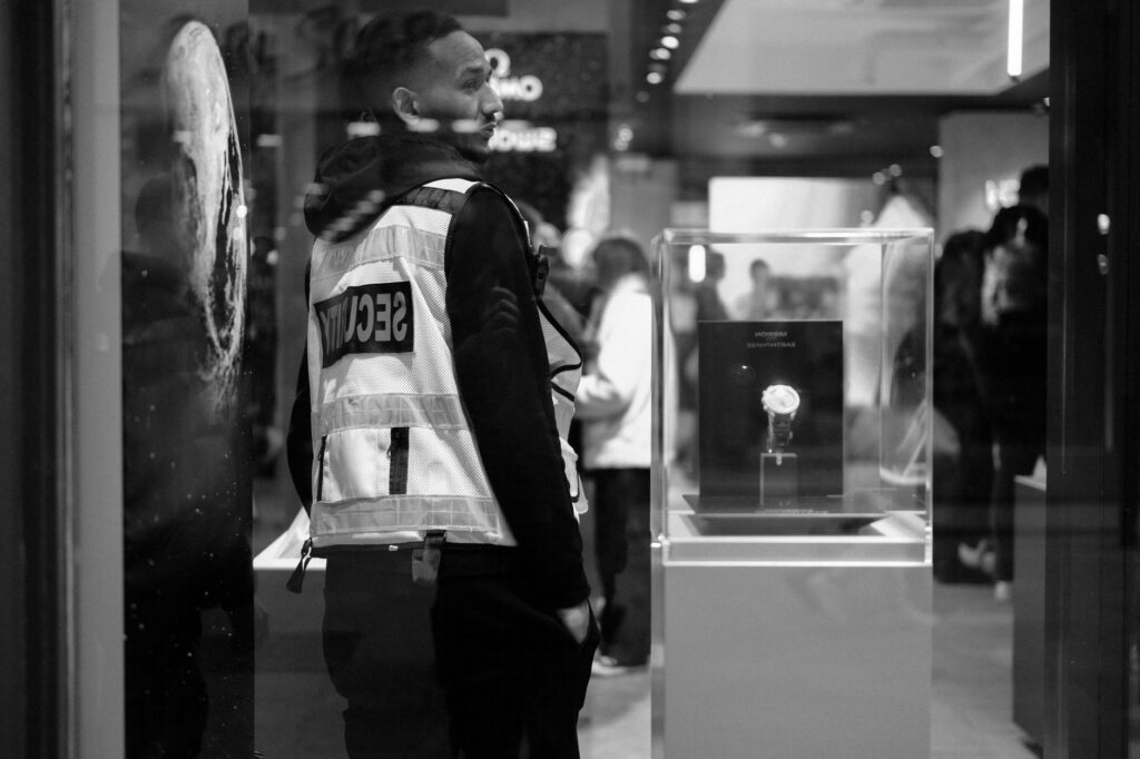 Security guard in a luxury Dublin store at night, showcasing urban security and retail ambiance.